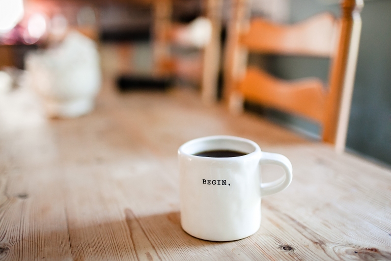 Photo of a mug with the word Begin printed on it.